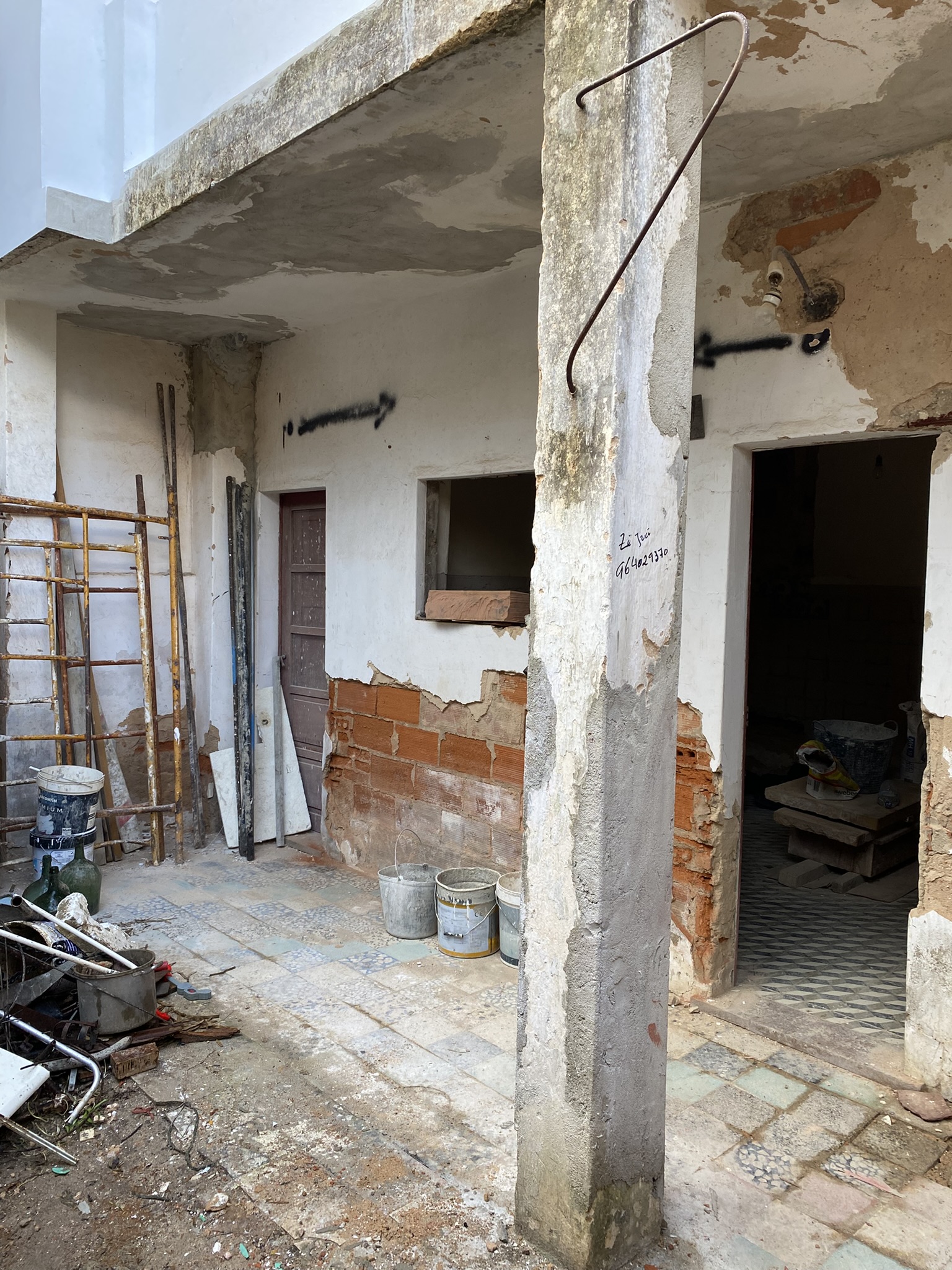 Courtyard image of kitchen wall and shared hallway door